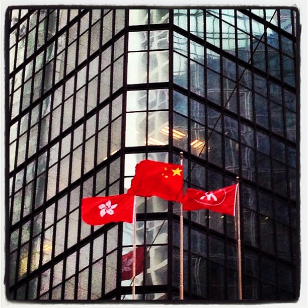 The East is Red. #hongkong #china and #mtr flags flying on a windy day.