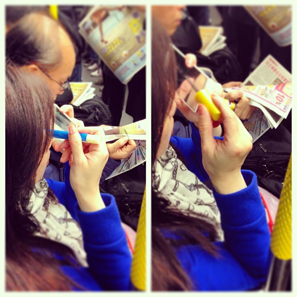 In a #rush? Fret not just put on your #makeup on the #MTR. It's just another #hongkong #morning commute.