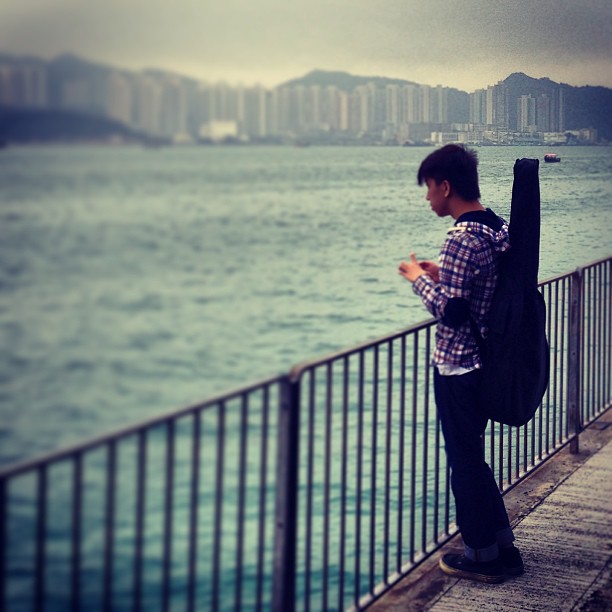 #boy #guitarist staring pensively into the #sea. #hongkong #hk #hkig