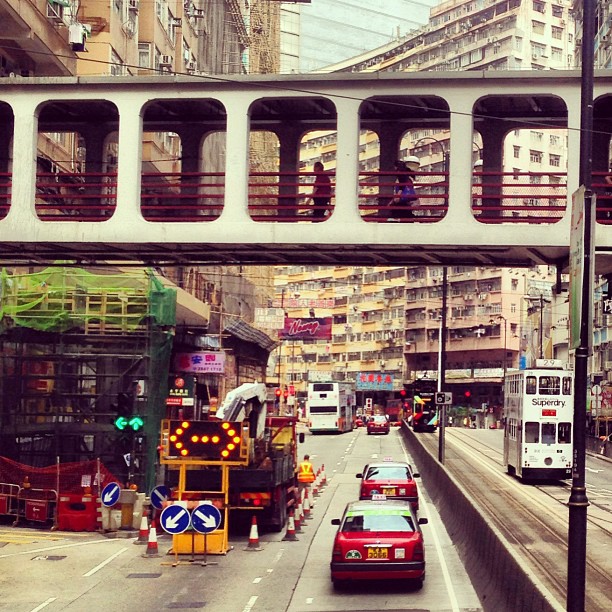 A typical #hongkong #street scene - #taxi, #tram, #roadworks and a #pedestrian #bridge. #hk #hkig
