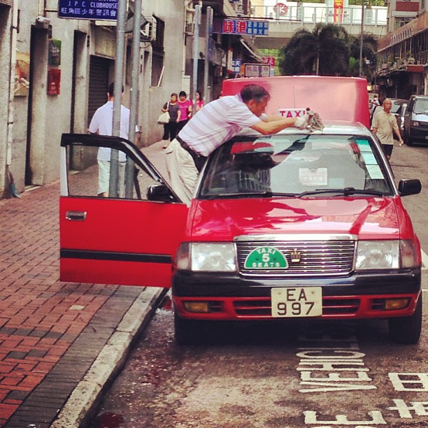 A #taxi #driver cleans his #car in preparation for the #morning shift. #hongkong #hk #hkig