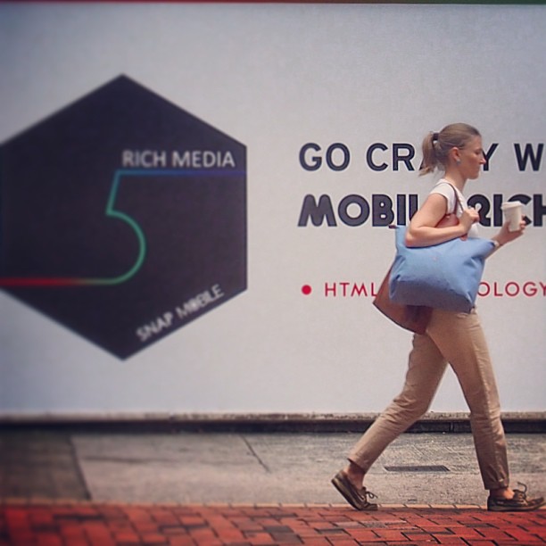 What's the #rush on a #sunday morning? A #lady walks past a #billboard in #QuarryBay. #hongkong #hk #hkig