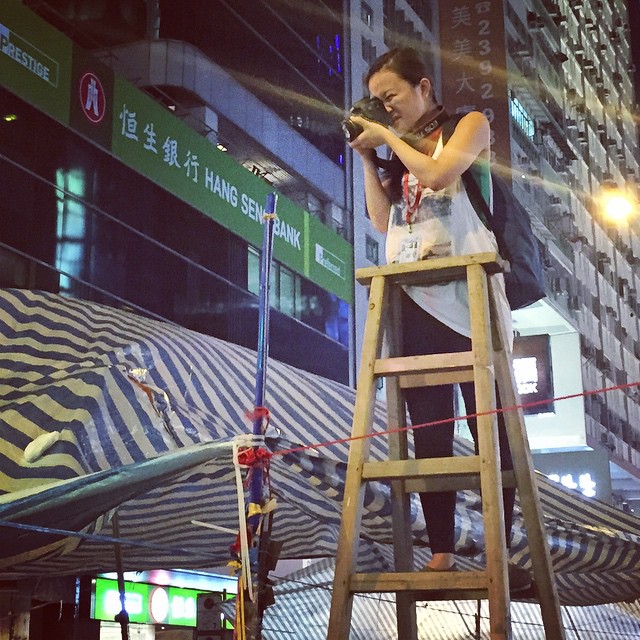 Above the #OccupyHK crowd in #Mongkok, the #photographer is photographed. One thing is clear, this revolution is heavily televised, photographed, Instagramed, Vined, panorama-ed, droned, gopro-ed and everything in-between. Never have so many image capturing devices been present for such a protest. #HongKong #hk #hkig