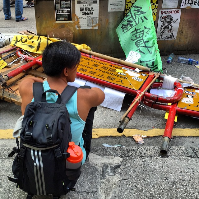 An #OccupyHK #protester sitting next to a destroyed #barricade this morning in #Mongkok during the clear out. #HongKong #hk #hkig