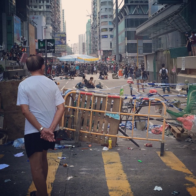 Dawn breaks on embattled day 8 of #OccupyHK in #Mongkok. An old man walks past an crumbling #barricade. #HongKong #hk #hkig