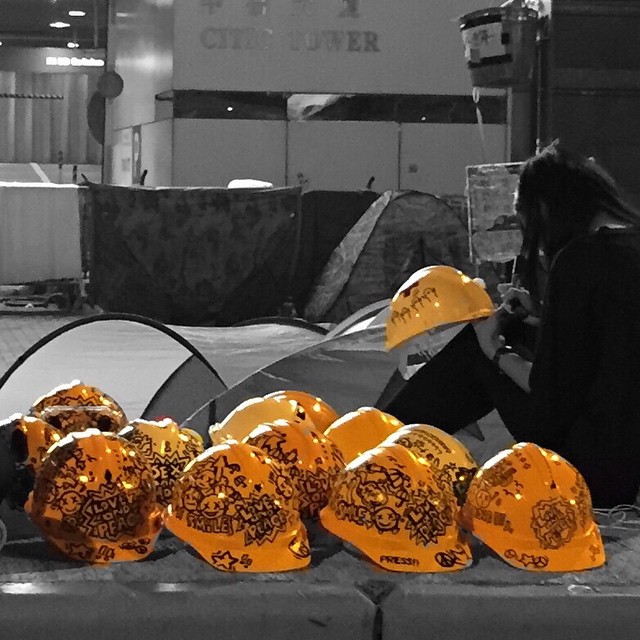 Just because they're #hardhats doesn't mean they have to be dull. An #OccupyHK protester who in #Admiralty decorates hardhats with a marker. #HongKong #hk #hkig