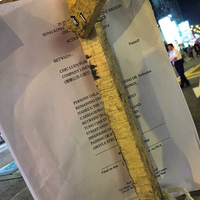 Latest development at #OccupyHK #Mongkok - a bus company is fed up with the road blockage and has decided to #sue... everyone. The #Writ of #Summons attached to the #barricade literally refers to everybody. #HongKong #hk #hkig