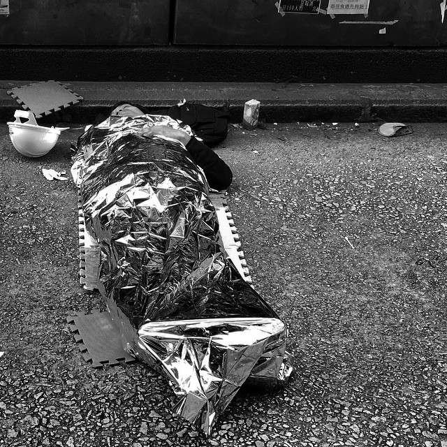 Not a breakfast #burrito - it's an #OccupyHK #protester sleeping on #NathanRoad after a long night of clashes with the police in #Mongkok. In case you don't know those #foil #blankets are quite popular with campers as emergency outdoor cover. #mono #HongKong #hk #hkig