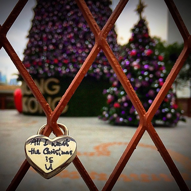 Merry #Christmas from #HongKong. A #heart-shaped #lock on a #fence with a #ChristmasTree background. #HK #hkig