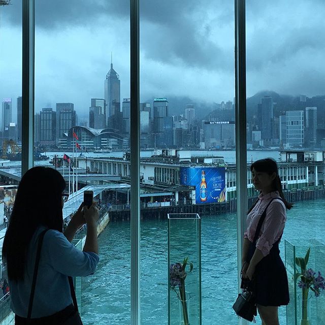Ladies pose for pictures by the #picturewindow. #victoriaharbour, #HongKong island and the #TsimShaTsui #StarFerry #pier are in background on a rainy day. #HK #hkig