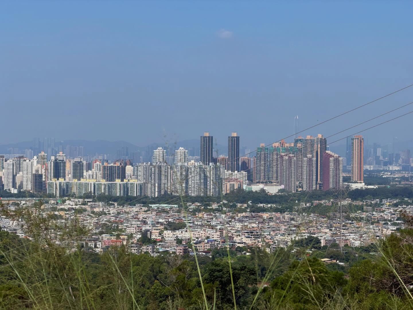 Yuen Long in the distance. The old villages lie before the city center with the looming towers. hongkong hk hkig yuenlong village building newterritories