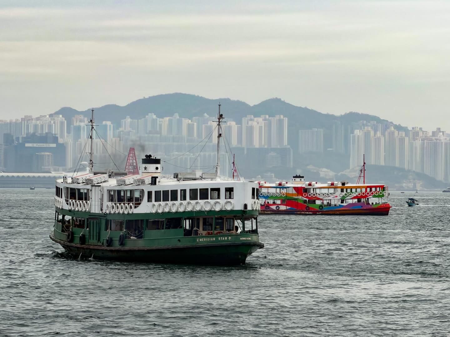 The Hong Kong Star Ferry, traditional and HKTB designs, on Victoria Harbour.